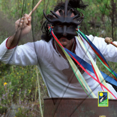 Il musicista guarda in camera suonando un barile.